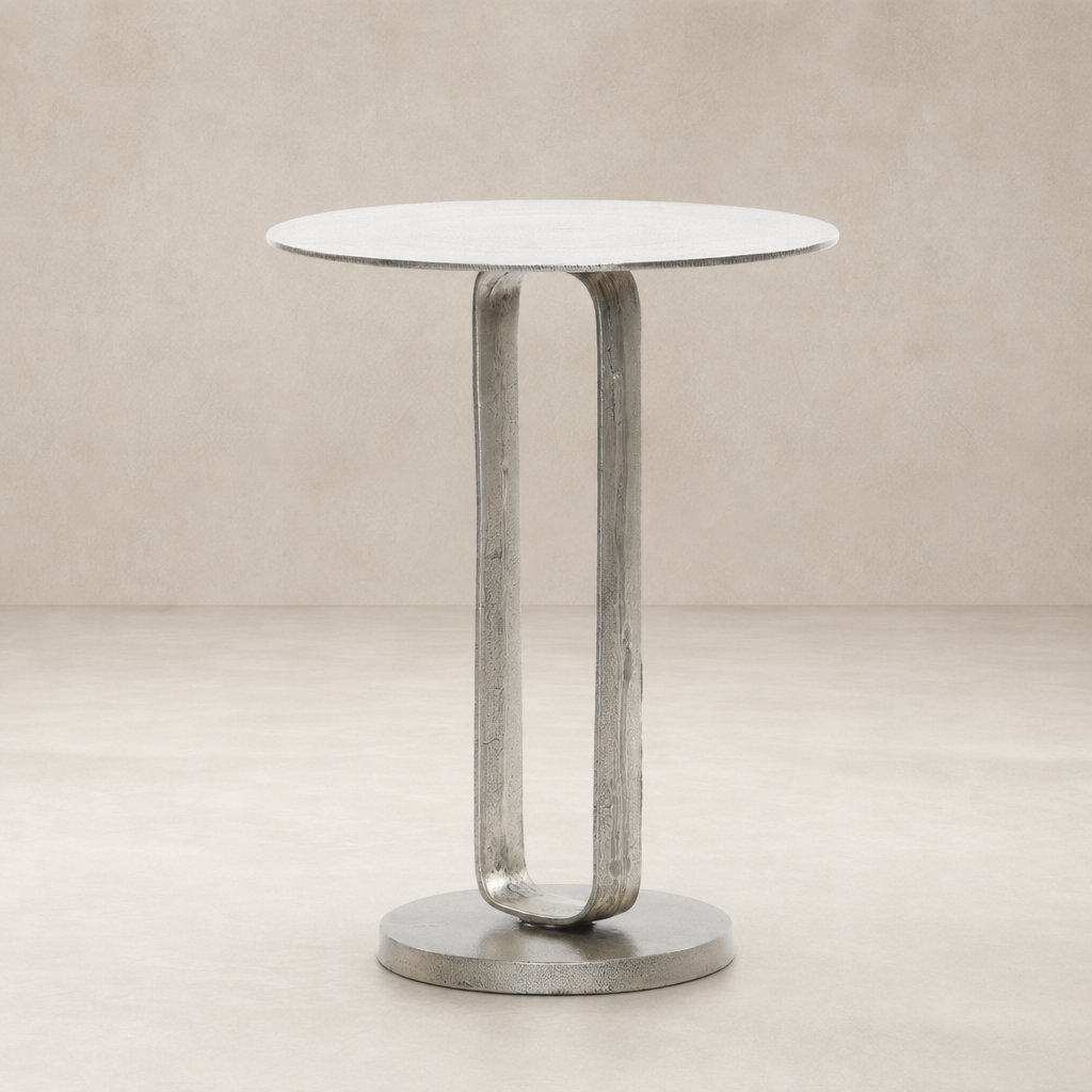 Rowan End Table featuring a sleek round top and a unique curved metal base.