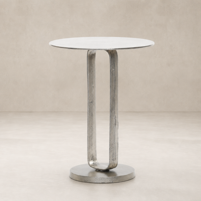 Rowan End Table featuring a sleek round top and a unique curved metal base.