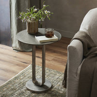 Round Rowan End Table with textured surface and modern metal base in a cozy living room.