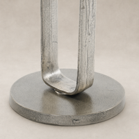 Rowan End Table featuring a sleek, brushed metal base and round, textured top.