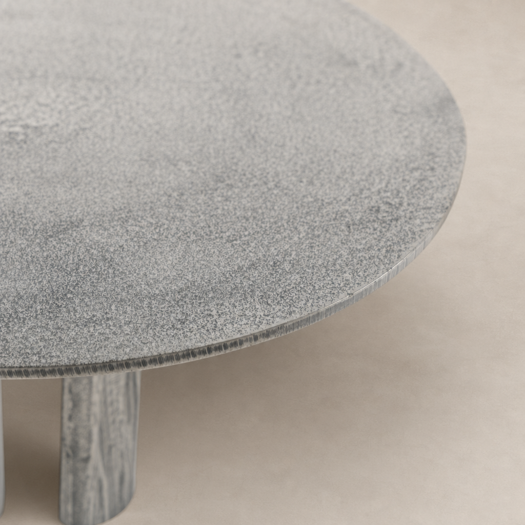 Rowan End Table featuring a round top with unique textured finish and sturdy wooden legs.