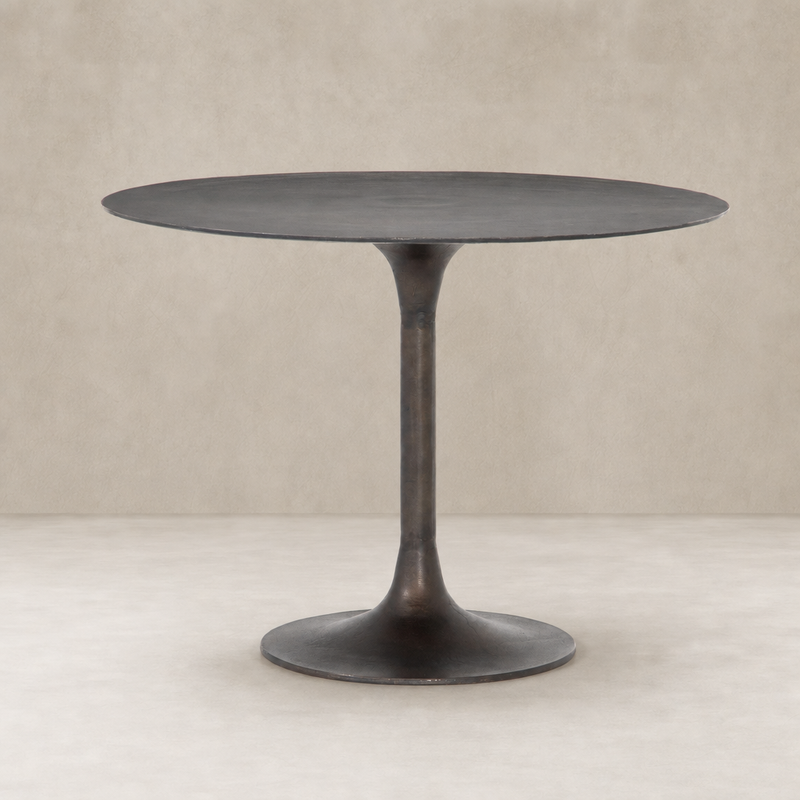 Kensington Bistro Table in Antique Rust with a sleek round top and tapered base.