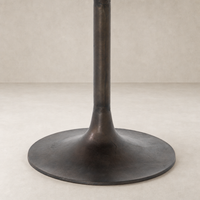 Antique Rust Kensington Bistro Table featuring a sleek, round base and sturdy support.