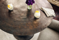 Kensington Bistro Table in Antique Rust with textured surface and elegant tapered base.