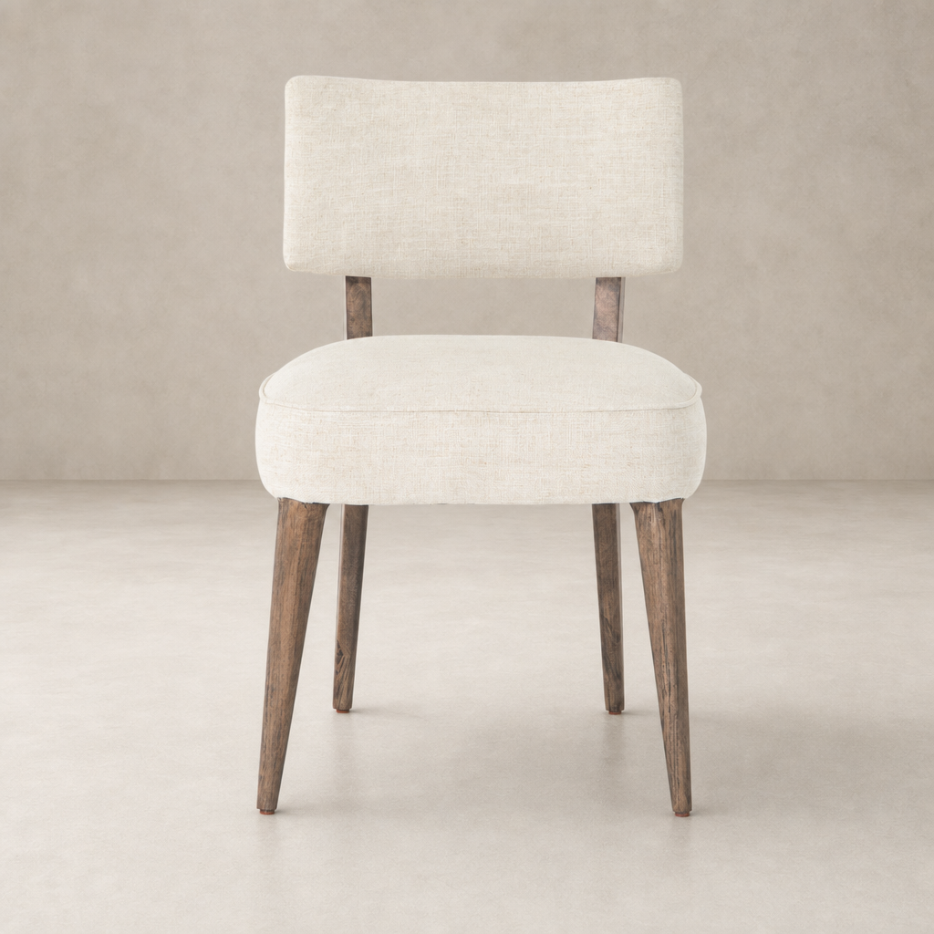 Orson Dining Chair in Cambric Ivory with a chic, minimalist design and wooden legs.