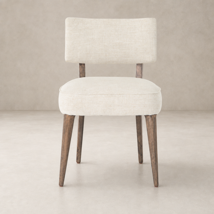 Orson Dining Chair in Cambric Ivory with a chic, minimalist design and wooden legs.