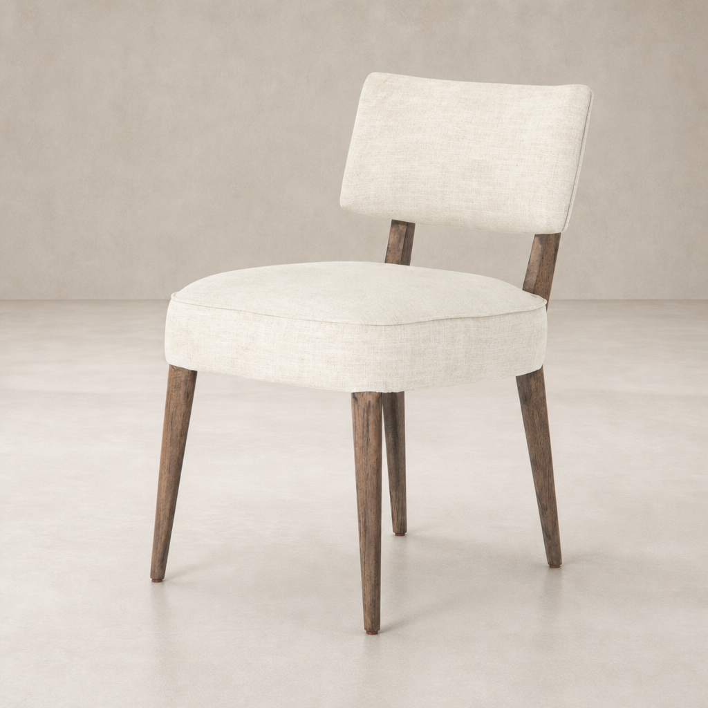 Orson Dining Chair in Cambric Ivory with wooden legs and a sleek, minimalist design.