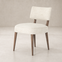 Orson Dining Chair in Cambric Ivory with wooden legs and a sleek, minimalist design.
