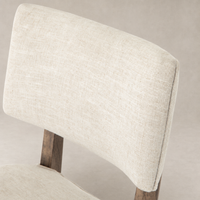 Close-up of the Orson Dining Chair in Cambric Ivory showcasing its textured fabric upholstery.