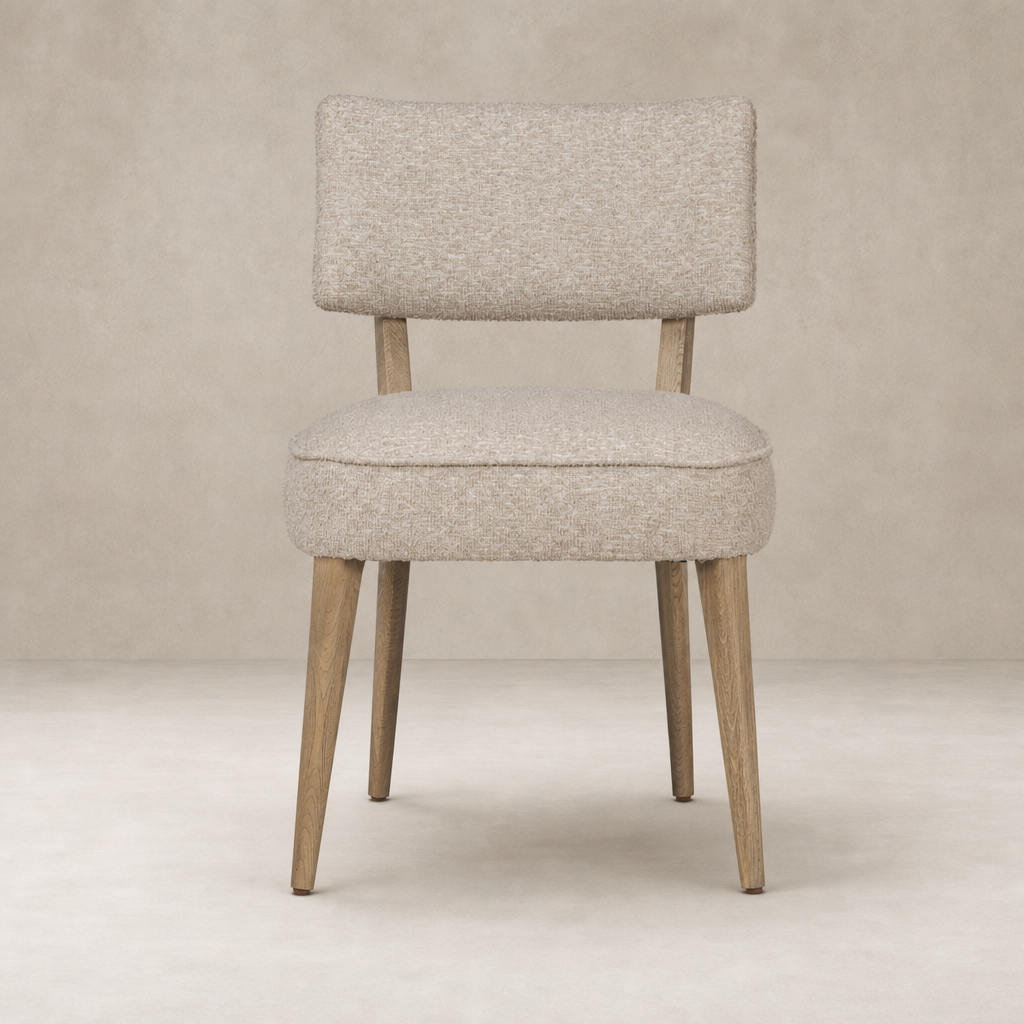 Orson Dining Chair in Mortensen Linen with a cushioned seat and wooden legs.