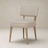 Orson Dining Chair in Mortensen Linen with a soft-textured seat and angled wooden legs.
