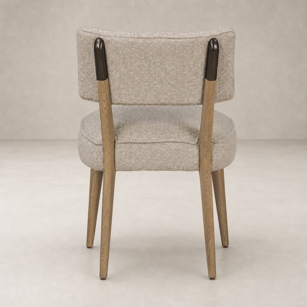 Orson Dining Chair in Mortensen Linen with a rounded back and wooden legs.