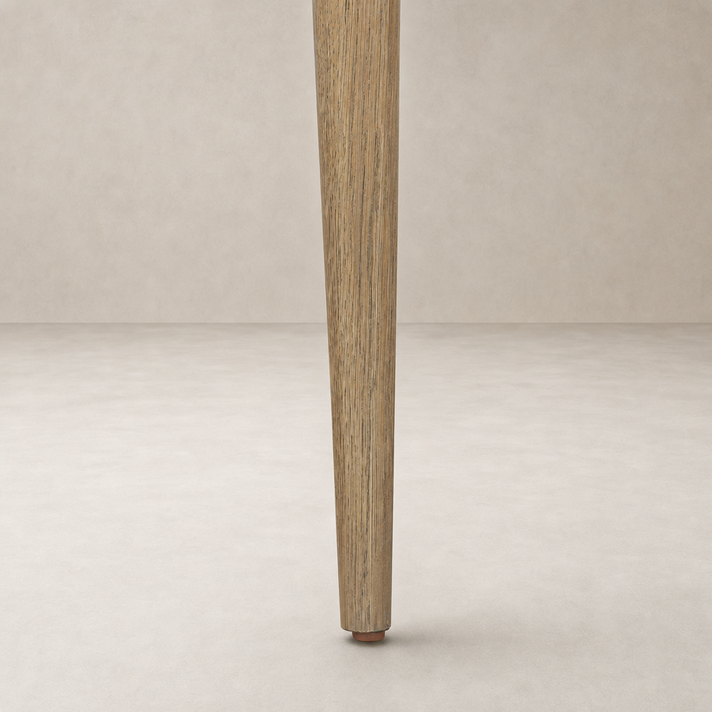 Mortensen Linen Orson Dining Chair showcasing a tapered wooden leg with natural finish.