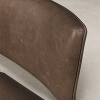 Close-up of the Orson Dining Chair in Palermo Cigar, showcasing its rich texture and elegant shape.