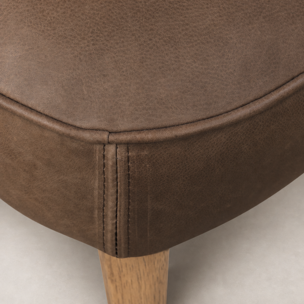 Close-up of Orson Dining Chair in Palermo Cigar, showcasing premium textured upholstery and stitching details.