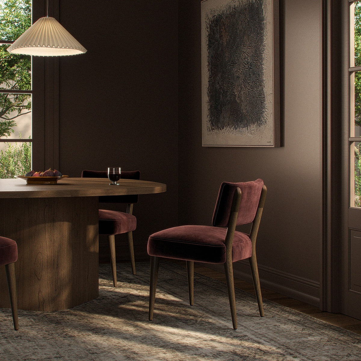 Orson Dining Chair in Surrey Plum featuring plush upholstery and elegant wooden legs in a stylish dining setting.