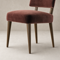 Orson Dining Chair in Surrey Plum velvet with sleek wooden legs and a contemporary design.