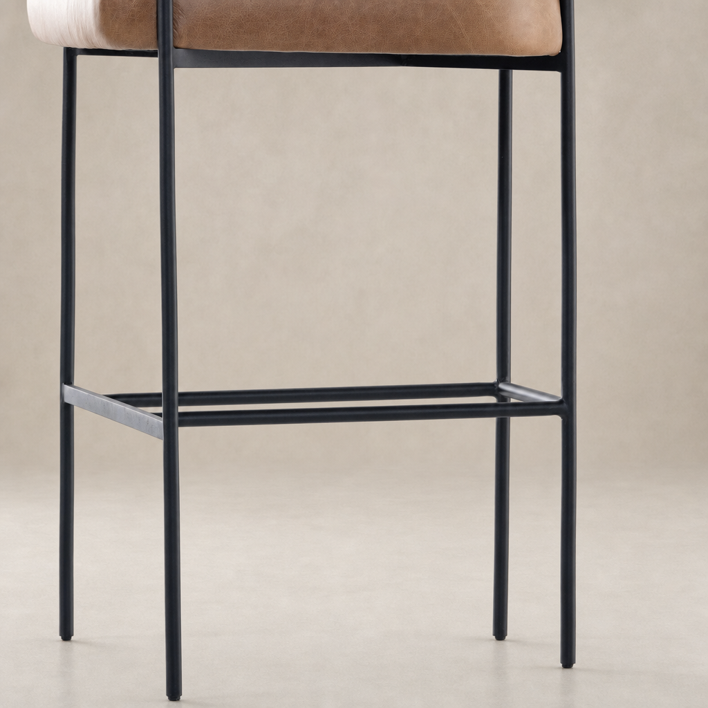 Banyan Bar + Counter Stool with Chaps Saddle seat and sleek black metal legs.