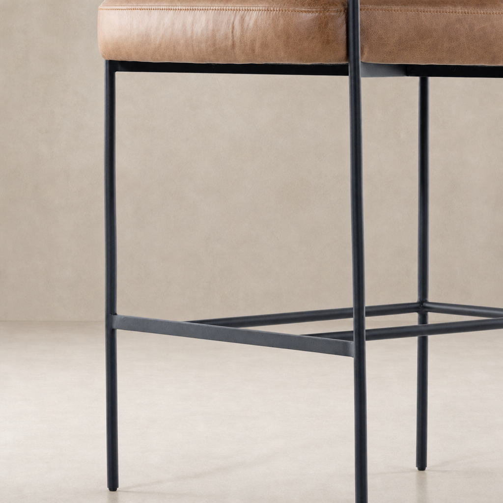 Banyan Bar + Counter Stool in Chaps Saddle features sleek metal legs and plush seating.