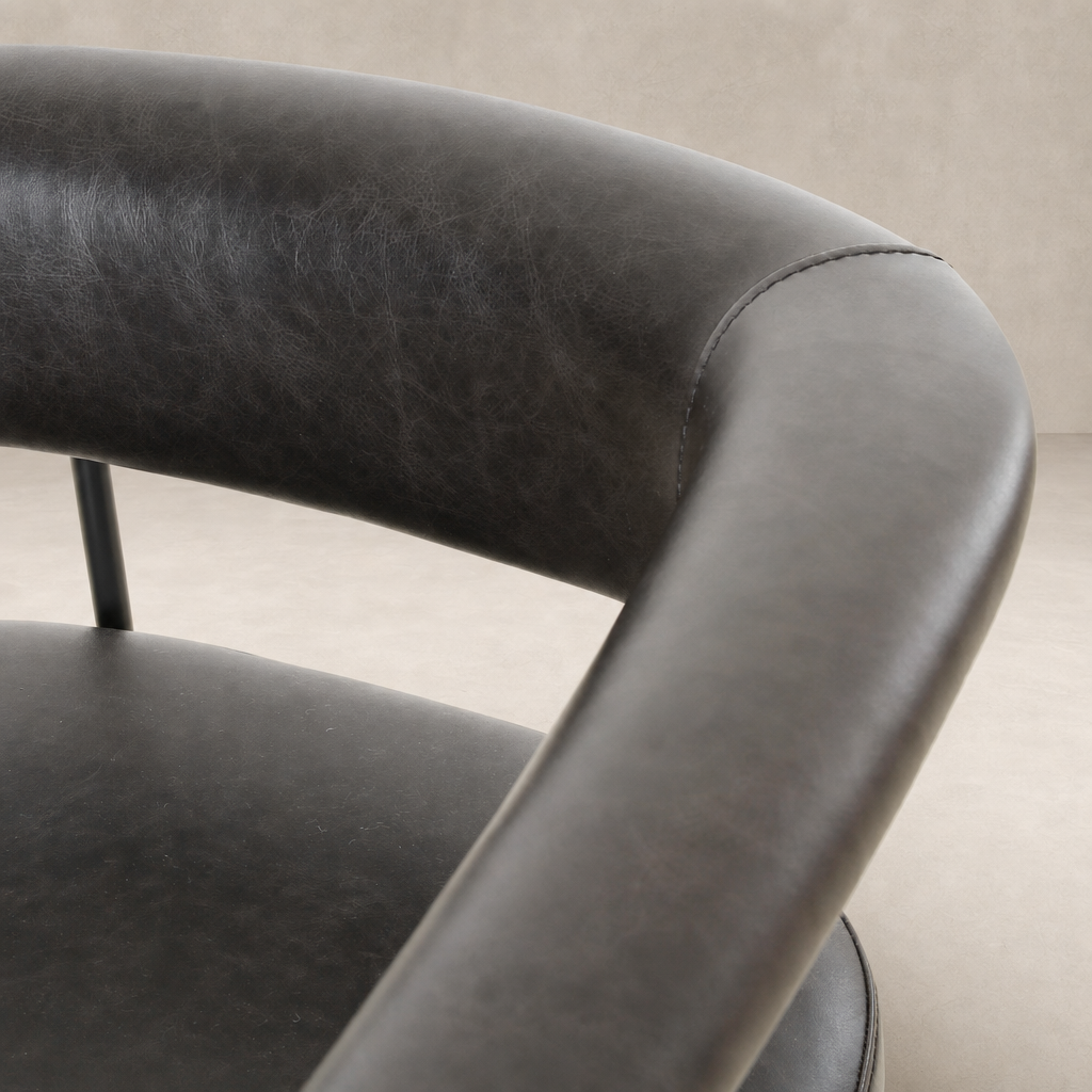 Banyan Bar + Counter Stool in Sonoma Black featuring a sleek, curved leather backrest.