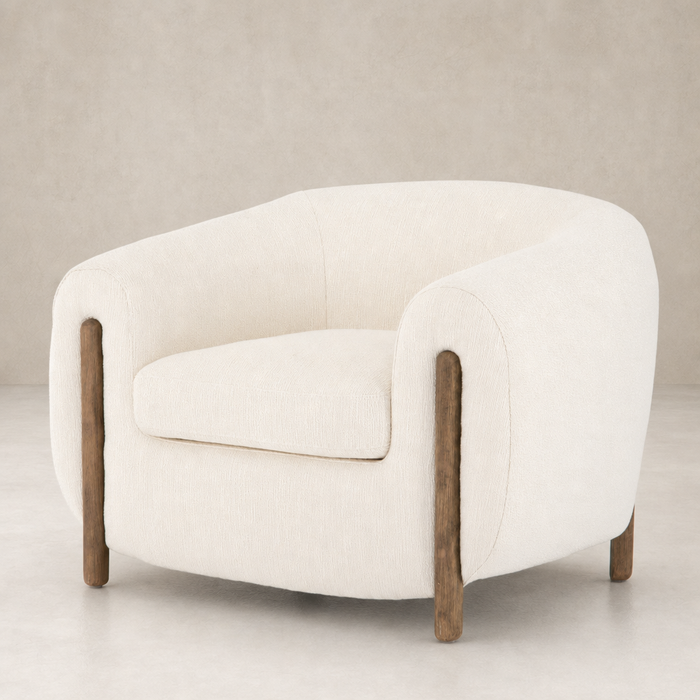 Clover Chair in Kerbey Ivory with rounded contours and wooden legs.