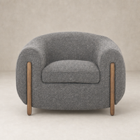 Clover Chair in Capri Ebony with rounded design and wooden legs, showcasing a textured finish.