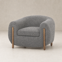 Clover Chair in Capri Ebony with rounded shape and wooden legs, featuring textured fabric.