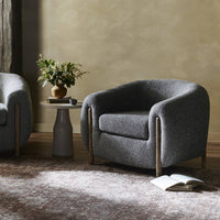 Clover Chair in Capri Ebony with curved fabric upholstery and wooden legs.