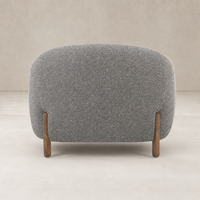 Clover Chair in Capri Ebony with rounded back and wooden legs, showcasing modern design.