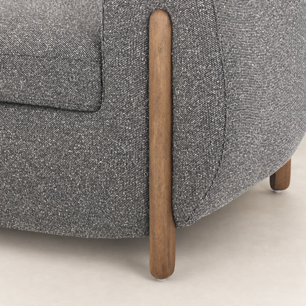 Clover Chair in Capri Ebony featuring rounded shape and wood legs.