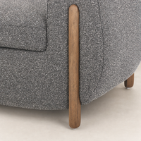 Clover Chair in Capri Ebony featuring rounded shape and wood legs.