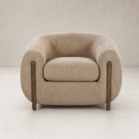 Clover Chair in Sheepskin Camel featuring rounded arms and polished wooden legs.