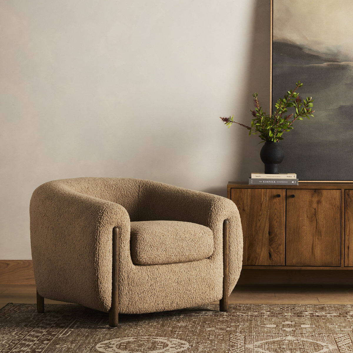 Clover Chair in Sheepskin Camel fabric, featuring a rounded design and plush texture.