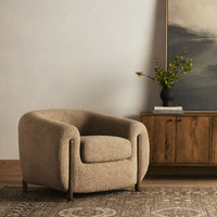 Clover Chair in Sheepskin Camel fabric, featuring a rounded design and plush texture.