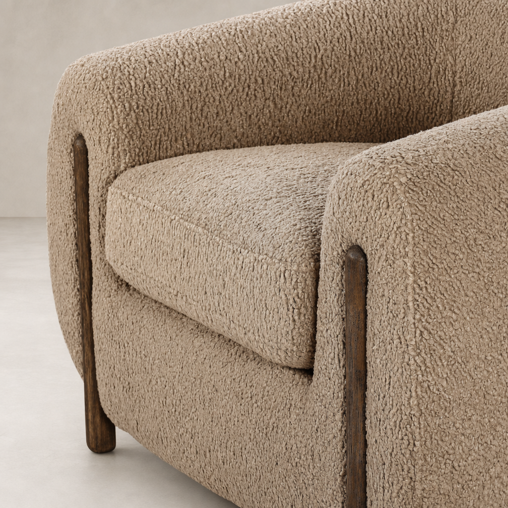 Clover Chair featuring cozy sheepskin camel upholstery and sleek wooden legs.