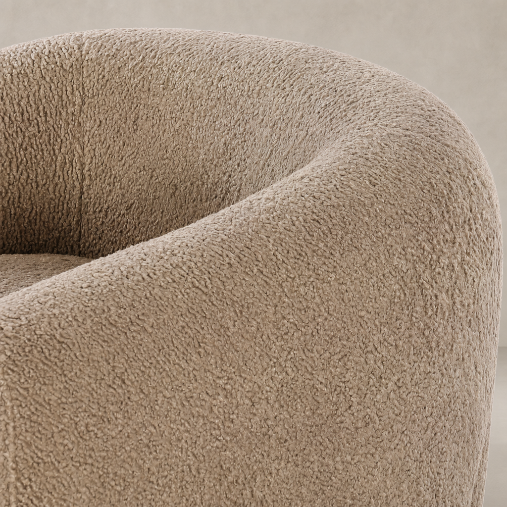 Clover Chair in sheepskin camel showcasing soft, textured fabric and rounded design.