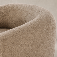 Clover Chair in sheepskin camel showcasing soft, textured fabric and rounded design.