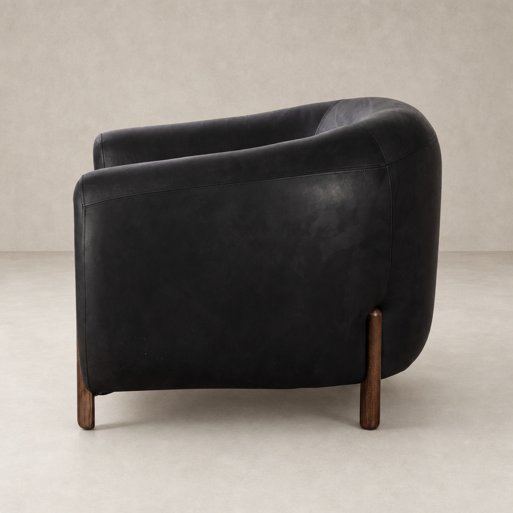 Clover Chair in Heirloom Black featuring a curved design and warm wooden legs.