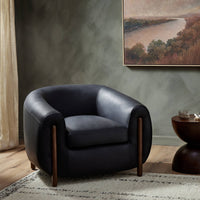 Clover Chair in Heirloom Black with rounded shape and wooden legs, styled in a cozy setting.