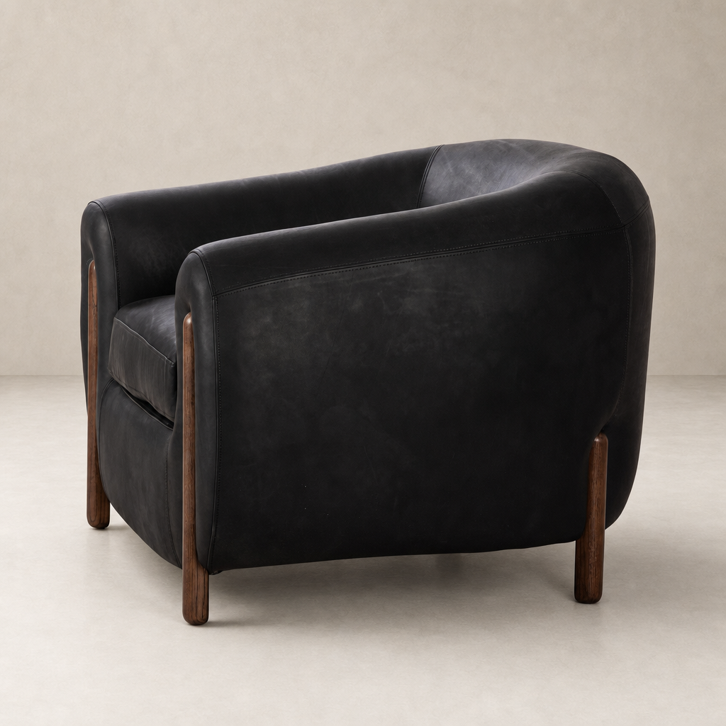 Clover Chair in heirloom black featuring a sleek, curved design and wooden legs.