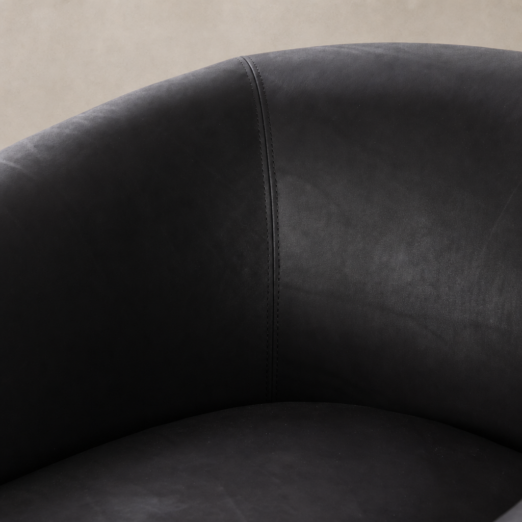 Clover Chair in heirloom black showcasing smooth, luxurious upholstery and elegant stitching detail.