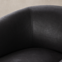 Clover Chair in heirloom black showcasing smooth, luxurious upholstery and elegant stitching detail.