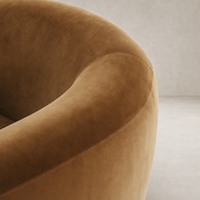 Clover Chair in Surrey Ochre showcasing soft, velvety texture and curved design.
