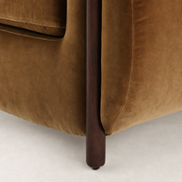 Clover Chair in Surrey Ochre featuring soft velvet upholstery and dark wooden leg.