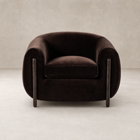 Clover Chair in Surrey Cocoa featuring soft upholstery and unique wooden legs.