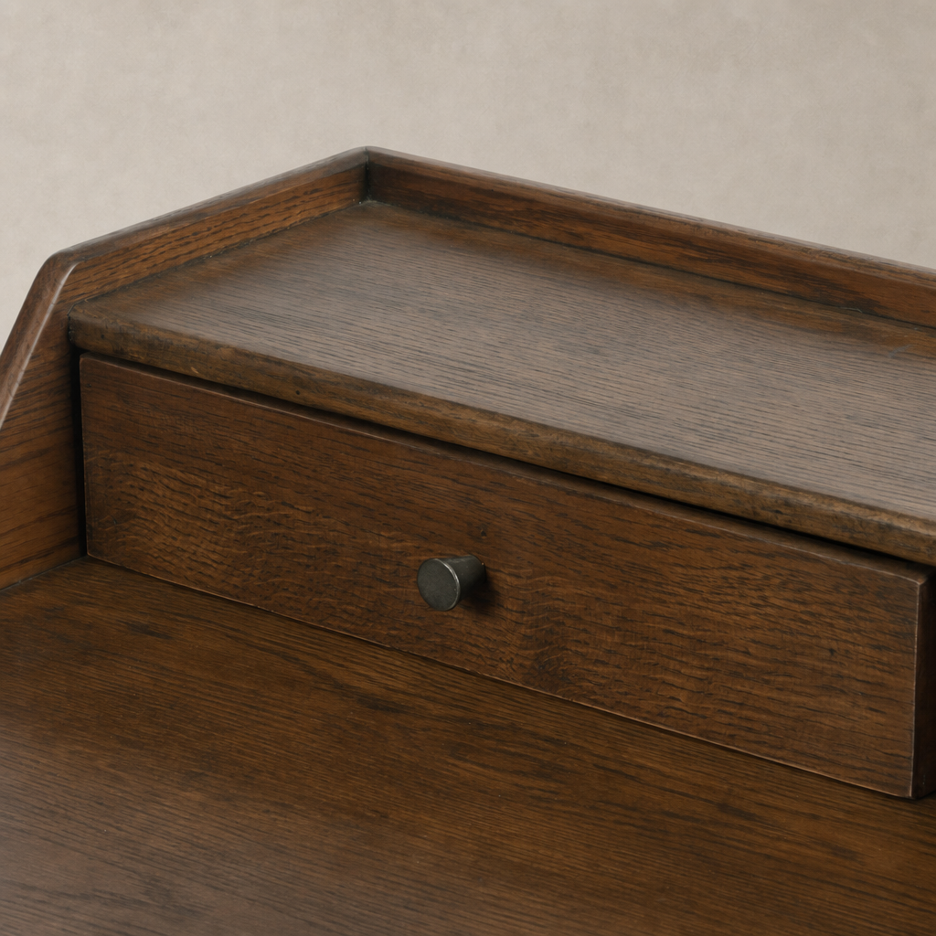 Quince Desk in Dark Toasted Oak with a sleek drawer featuring a round metallic knob.