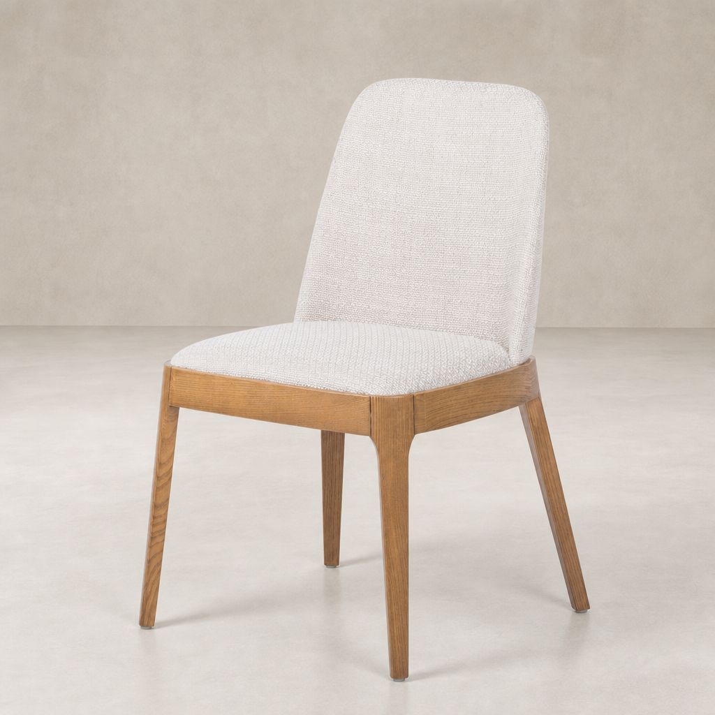 Rhys Armless Dining Chair in Gibson Wheat features a textured fabric seat and sleek wooden legs.