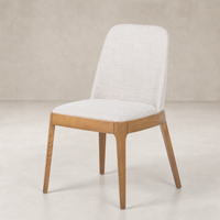 Rhys Armless Dining Chair in Gibson Wheat features a textured fabric seat and sleek wooden legs.