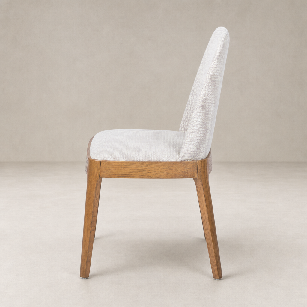 Rhys Armless Dining Chair in Gibson Wheat with a wooden frame and sleek design.