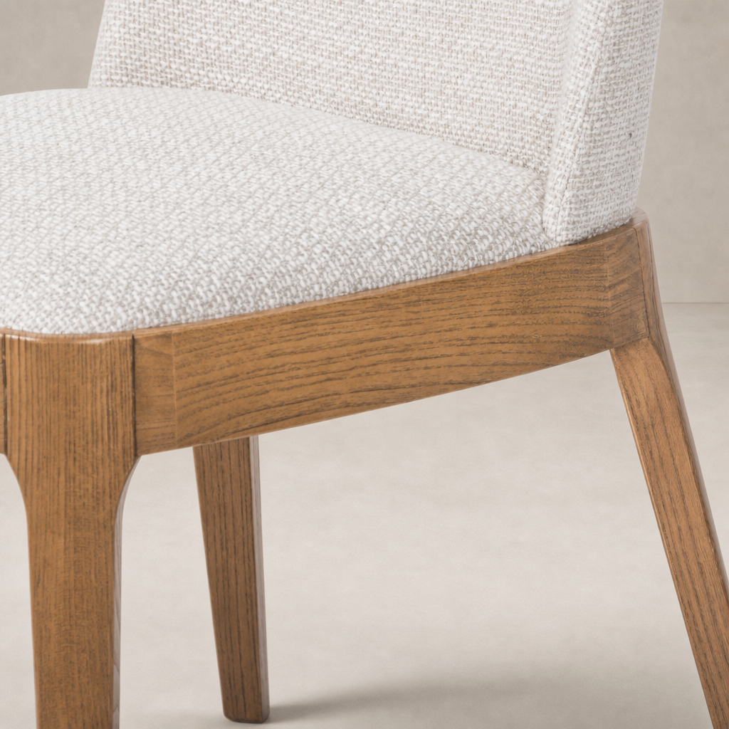 Rhys Armless Dining Chair in Gibson Wheat, featuring a textured seat and smooth wooden legs.